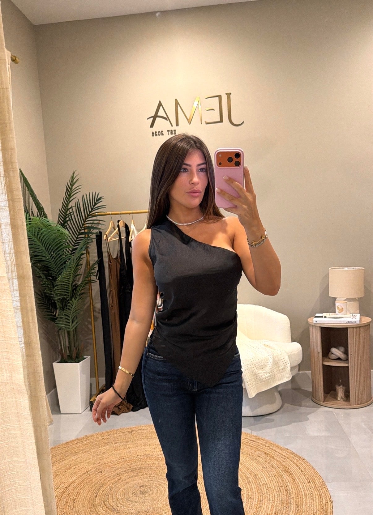Maddie Top - one shoulder satin top in black, worn with denim jeans